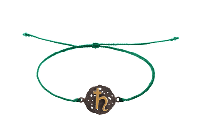 String bracelet with Saturn medallion amulet. Gold plated and oxide